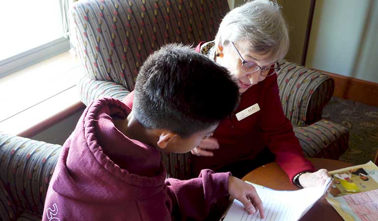 St. Edmunds Student Reading with Resident