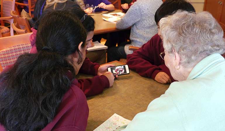 St. Edmunds School Students showing residents iPhone