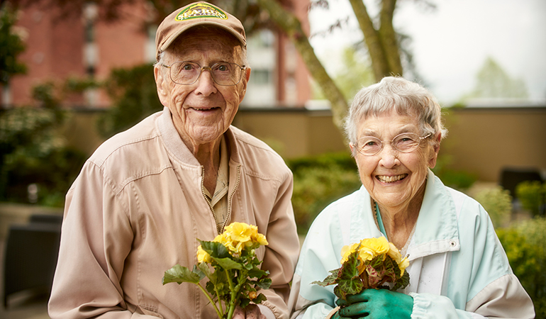 Mulberry PARC residents Bob and Virginia holding flower pots