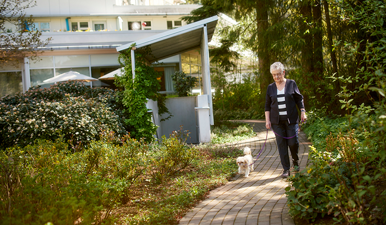 Cedar Springs PARC resident Cathy out for a walk with Daisy Mae