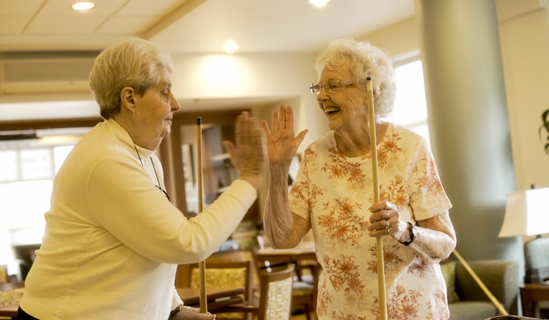 Summerhill PARC resident Peggy and friend high fives