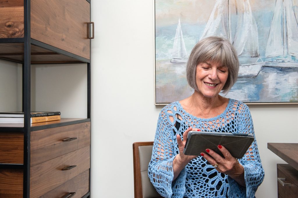 Senior Woman Smiling and Reading in her Room