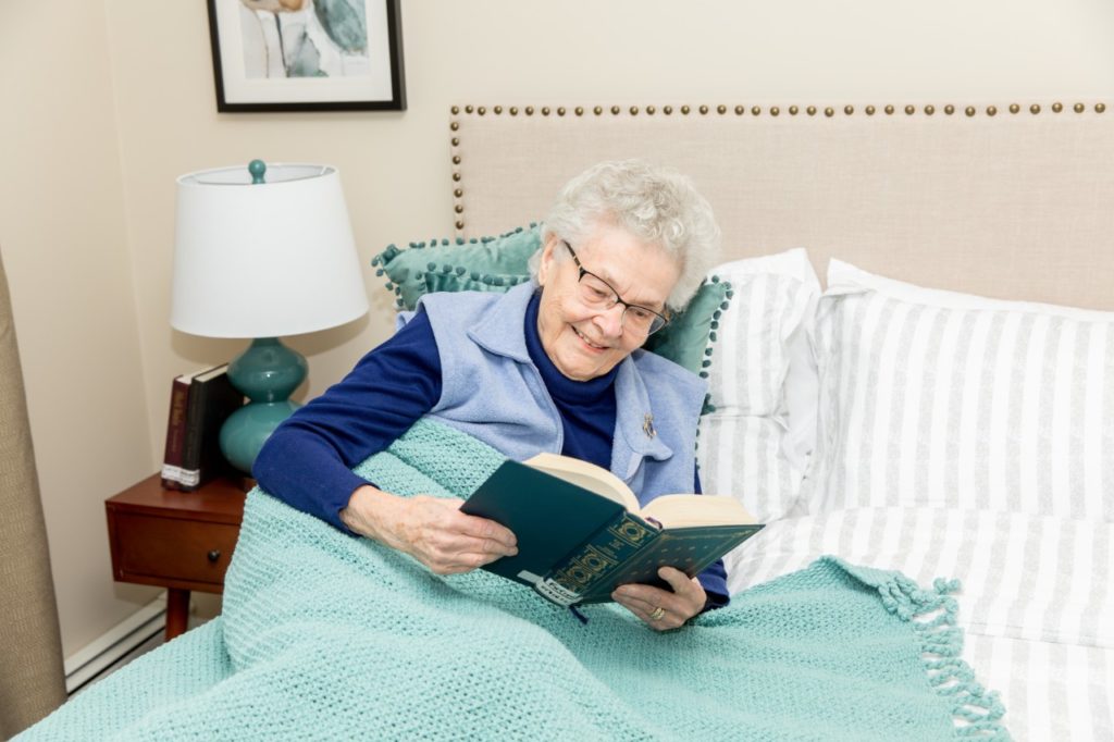 Mulberry PARC resident reading book in bed